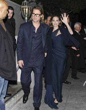 Angelina Jolie arriving in her navy White + Warren travel wrap to the “Blood and Honey” after party