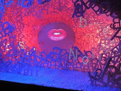 Video artist Bertrand Planes dresses the Bon Marche Paris holiday windows with a one with a pair of lips singing a rock n' roll Christmas surrounded by a pile of big white letters Video artist Bertrand Planes dresses the Bon Marche Paris holiday windows with a one with a pair of lips singing a rock n' roll Christmas surrounded by a pile of big white letters