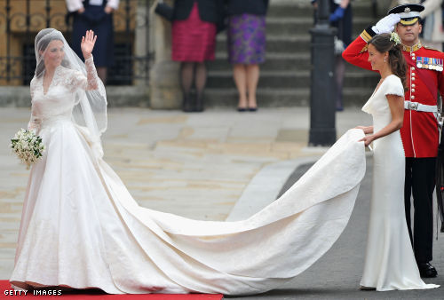 Catherine Middleton waves to the crowds as her sister and Maid of Honour Pippa Middleton holds her dress Catherine Middleton waves to the crowds as her sister and Maid of Honour Pippa Middleton holds her dress